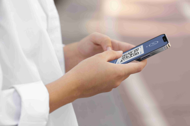 Eine Frau hat eine eSIM von esimschweiz.com gekauft und hält ein Smartphone in der Hand, auf dem sie die eSIM per QR-Code-Scan für die Schweiz installiert.